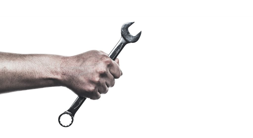 Hand holding wrench